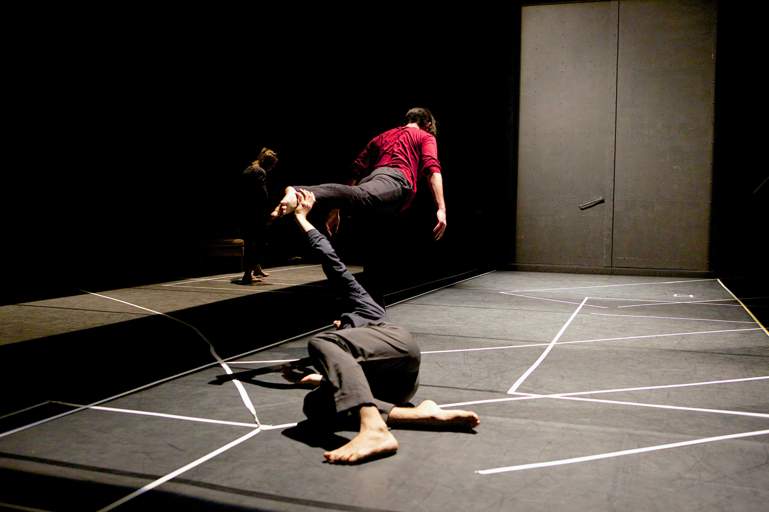 two dancers performing on dimly lit stage