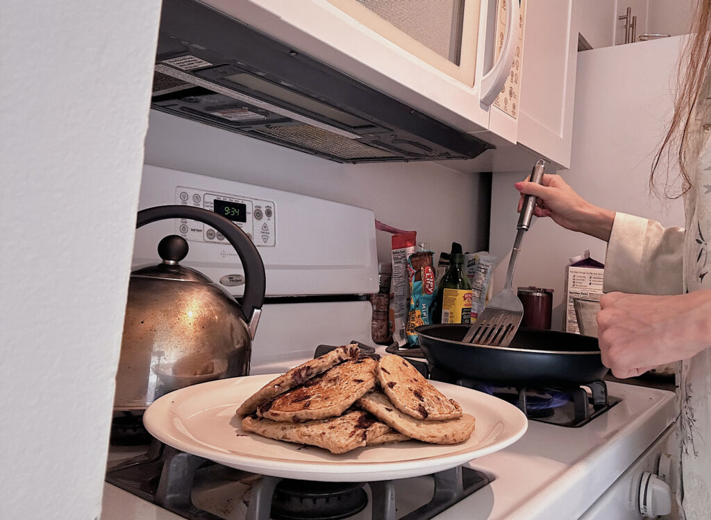 a stack of pancakes on the stove