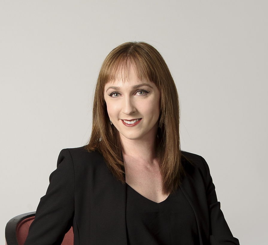 a woman with brown hair smiling at the camera 