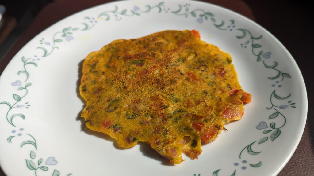 a pancake shaped food on a glass plate