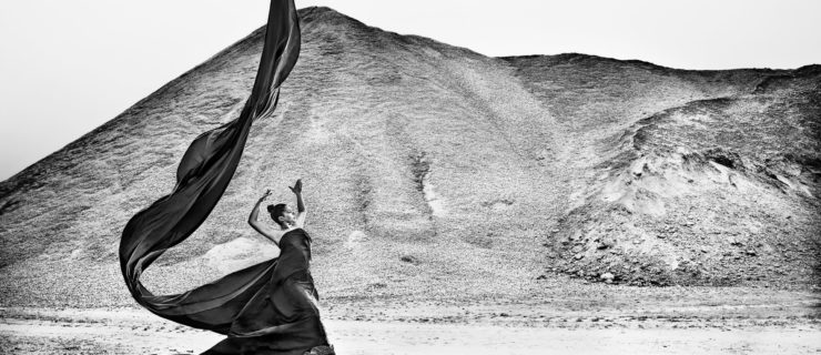 dancer in long dress by mountain