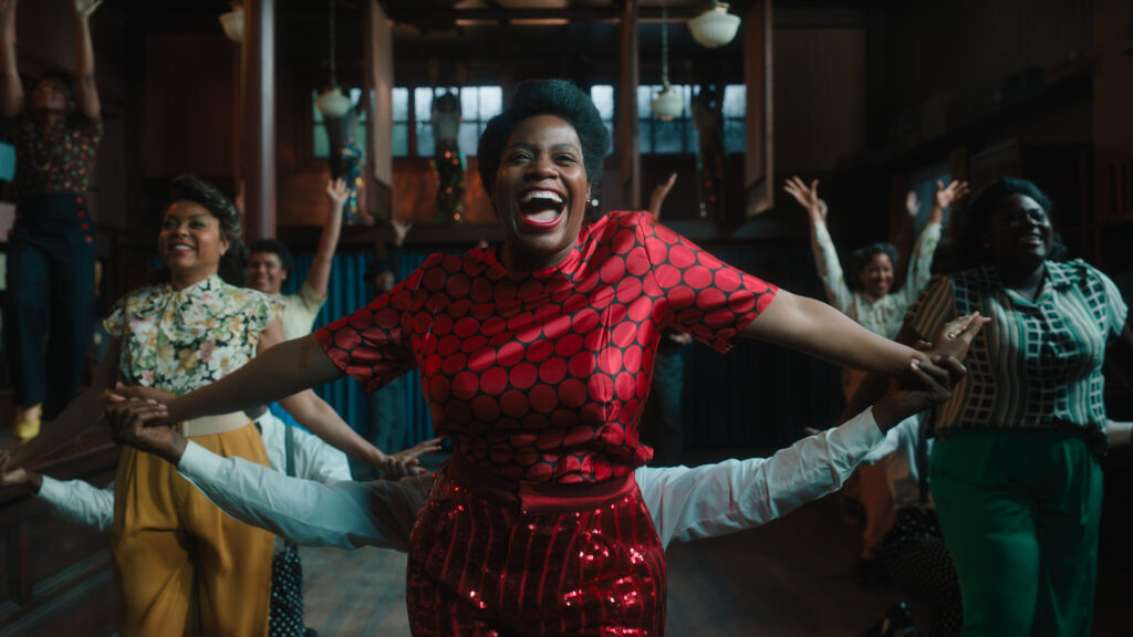 Barrino, Henson, and Brooks are captured mid-song, throwing their arms exuberantly out to the sides