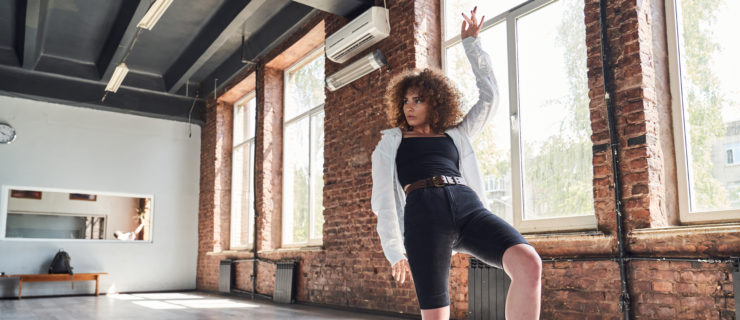 Graceful young woman dancing in sport studio