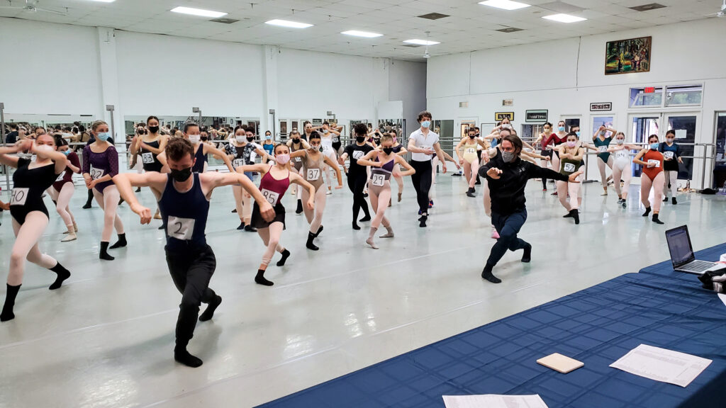 large group of dancers wearing numbers