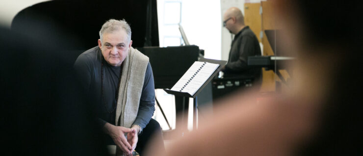 an older man sitting near piano