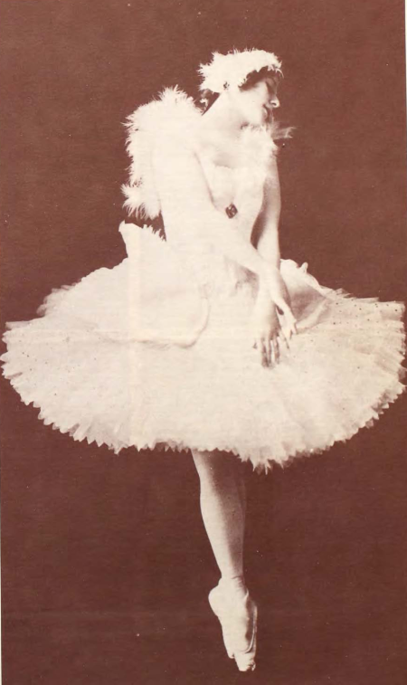 a female dancer wearing a white tutu dancing as a swan